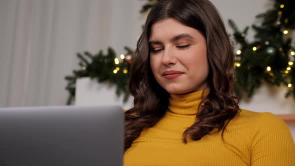 Close Up Smiling Young Woman Uses Laptop Online Chatting Christmas Holidays alt