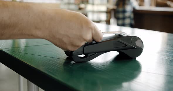Making Contactless Payment for Using Paying By Credit Card NFC Technology in Coffee Shop, Close Up alt