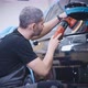 An Experienced Detailing Studio Worker Polishing a Car - VideoHive Item for Sale
