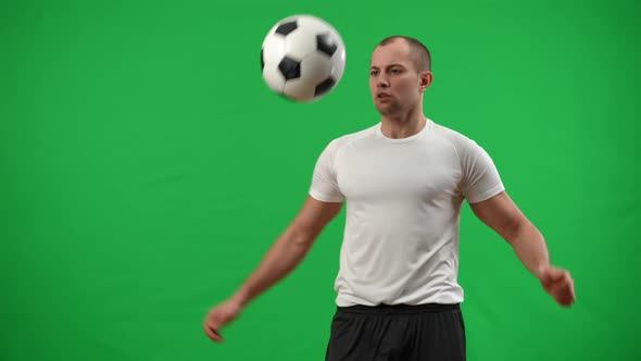 Concentrated Inspired Caucasian Football Player Catching Ball with Chest Juggling with Legs in Slow alt