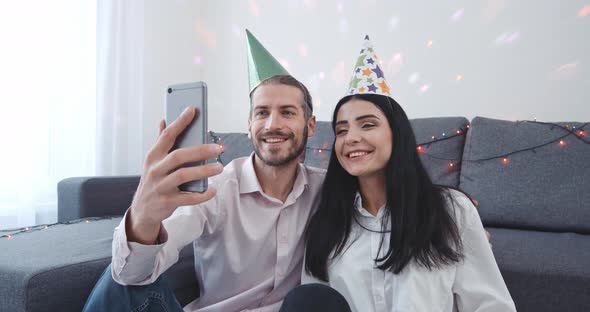 Celebrating Christmas, a Young Couple Sits on the Floor of Their New Apartment and Wishes Their alt