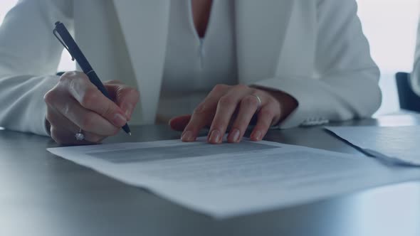 Closeup Woman Signing Contract in Suit alt