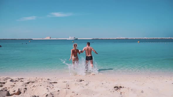 Loving Couple Runs into the Sea in Dubai