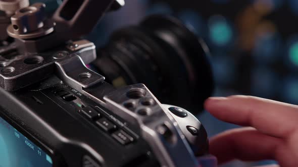 Closeup of the Videographer's Hand Adjusting the Focus on Camcorder