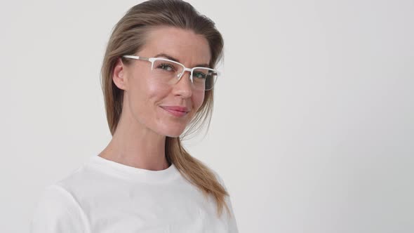 Beautiful Woman Putting on Glasses