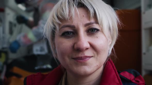 Friendly Female Doctor Near Ambulance alt