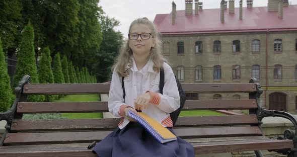 Girl Younger Schoolgirl with Glasses in School Uniform Writing Word Start alt
