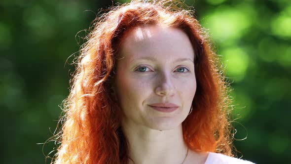 Portrait of a Red-Haired Young Adult Woman Outdoors