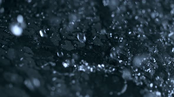 Super Slow Motion Shot of Water Splashing on Waterproof Cloth at 1000Fps alt