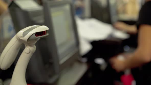 Woman Cashier Scans Barcode on alt
