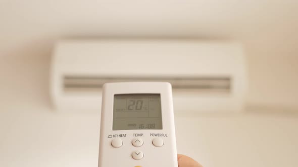 Split system air conditioner heating up with remote control 4K 2160p UltraHD footage - Air condition alt