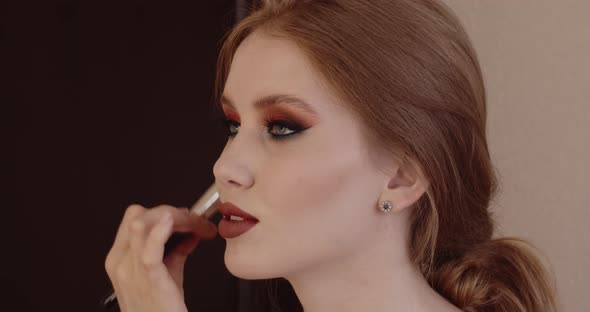 Beautiful girl has her makeup done in a beauty salon.