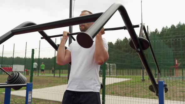 Man is Engaged in a Simulator on a Sports Field in the Park alt