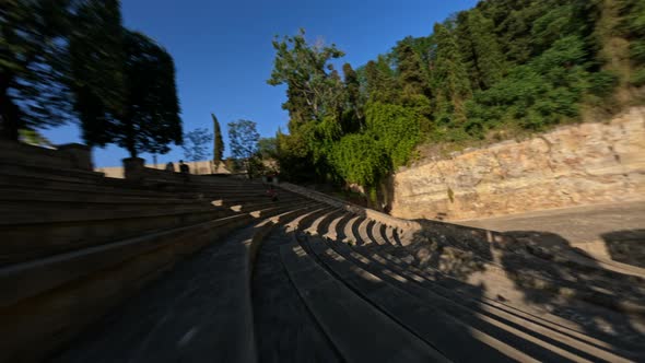 Dynamic Fpv Drone Shot Cruising Around Ancient Amphitheater Sunny Day