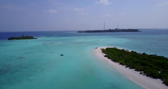 Daytime flying travel shot of a white paradise beach and aqua turquoise water background in vibrant  alt