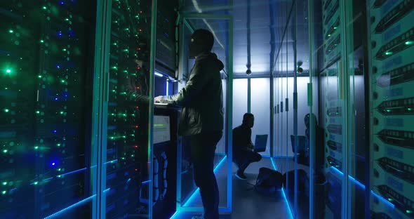 Two Hackers Beginning an Attack on Servers alt