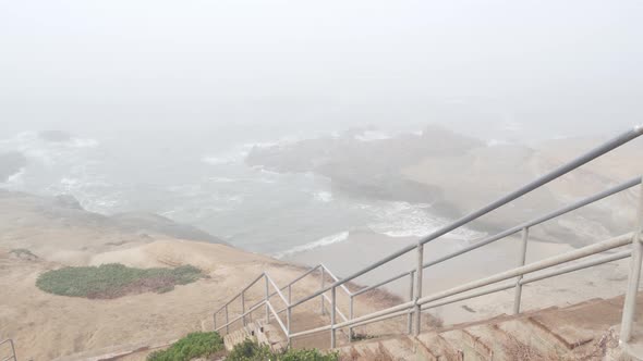 Foggy Sea Landscape Wave Crashing on Ocean Beach Stairs in Haze Misty Weather
