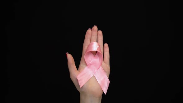 Hands Holding Breast Cancer Ribbon