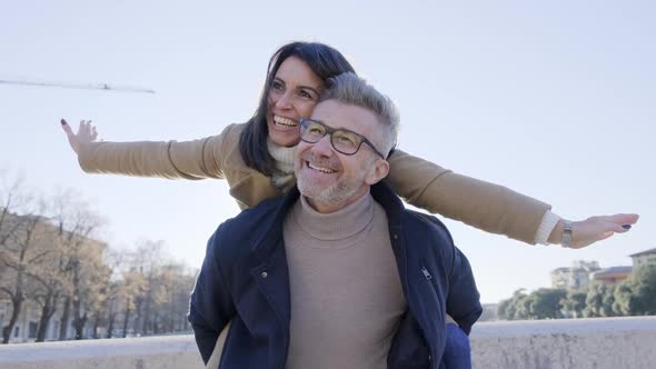 Adult couple in love having fun on city street