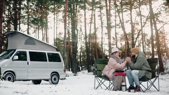 Romantic Couple Resting in the Woods on Sunny Winter Day Enjoying Van Life
