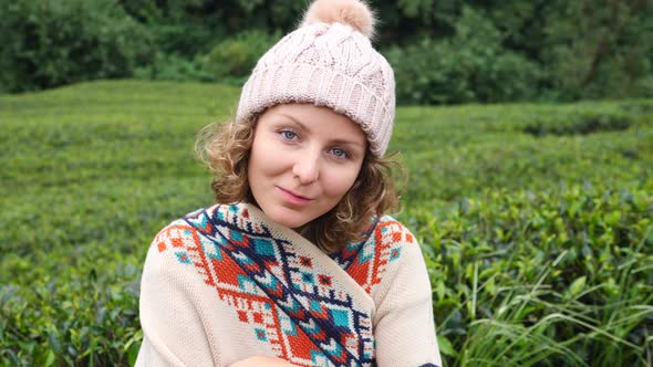 Young Woman Smiling Portrait Looking At Camera In Green Field