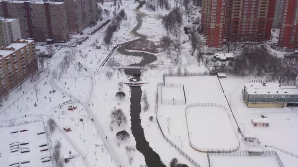 The River in the Middle of Modern Houses of the Sleeping Area in Winter