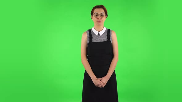 Funny Girl in Round Glasses in Anticipation of Worries, Then Guilty Hides Her Eyes. Green Screen alt
