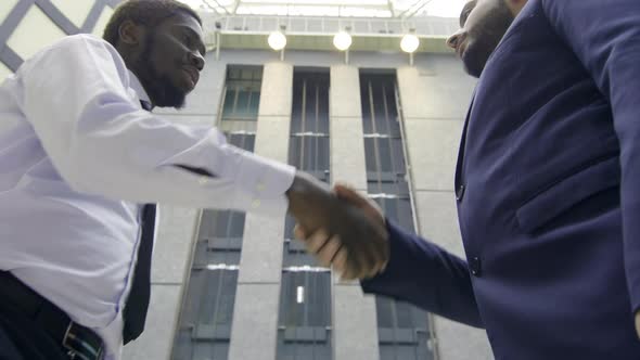 Businessmen shaking hands in office center