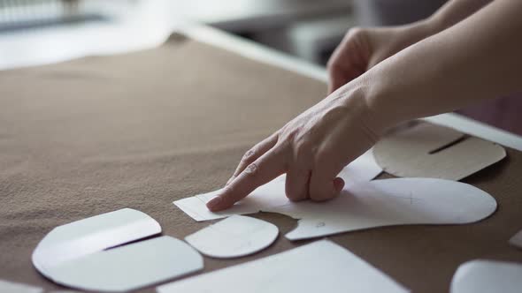 Female Dressmaker Uses Chalk on the Pattern Contour on Textile in Atelier alt