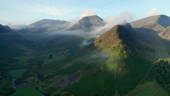 Aerial fly through the Honister Pass in the Lake District, Cumbria with mist. alt