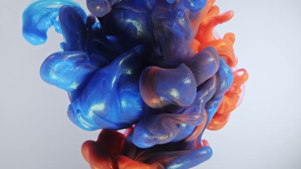 Colorful Nacreous Paint in Water Against White Background. alt