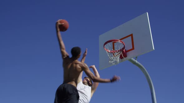 Slam dunk over defender in slow motion