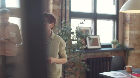 Two Female Colleagues Discussing Business Papers in Office alt