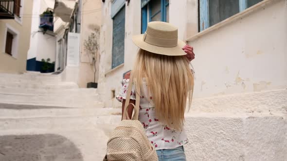 Beautiful Girl Tourist Walking in the Streets of Poros City Greece alt