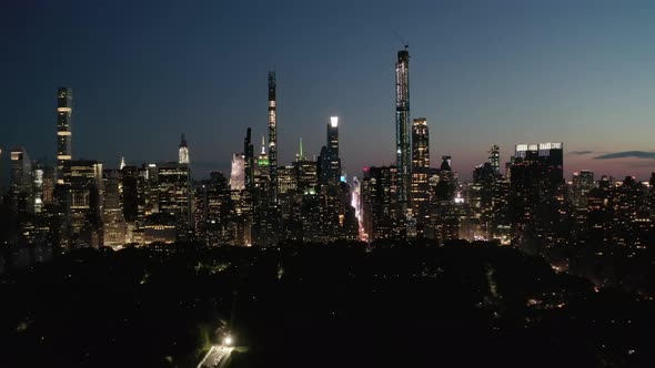 AERIAL: Time Lapse Hyper Lapse Over New York City Central Park at Night with Skyline View alt