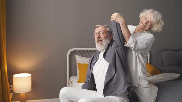 An Elderly Couple Takes Care of Each Other a Wife Massages Her Adult Spouse alt