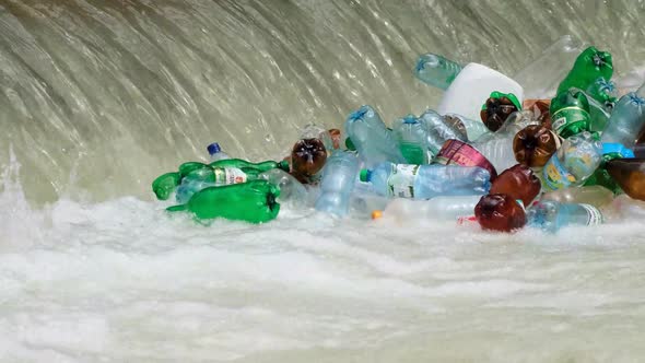 Lots of plastic trash in a mountain river. The problem of ecology alt