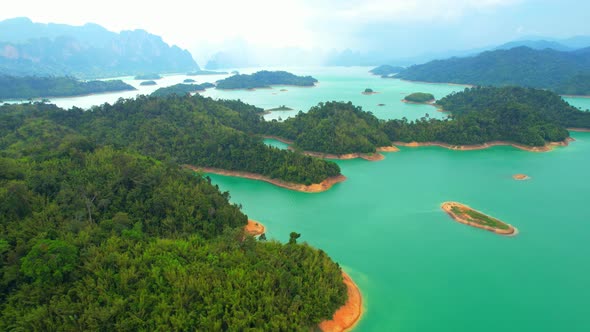 An aerial view from a drone flying over a dam, beautiful turquoise water alt