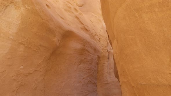 View of a narrow sandy Coloured Canyon in the desert, sandstone cliff close up alt