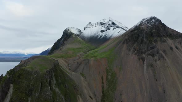 Drone Of Vestrahorn Mountain With Stream And Snow alt