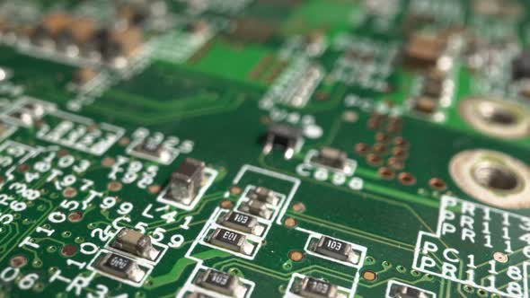 Extreme close-up of green Printed Circuit Board Electronics shot with dolly alt