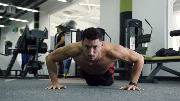 Caucasian Man Doing Push Ups in the Gym alt