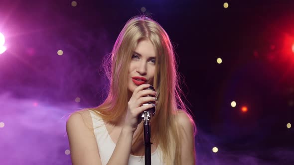 Sexy Woman Singing Into Retro Microphone Strobe Lighting and Smoke Effect alt