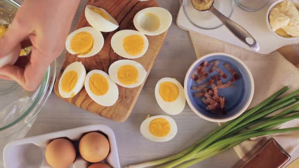 Preparing deviled eggs with organic eggs for appetizer. Step by step recipe. alt