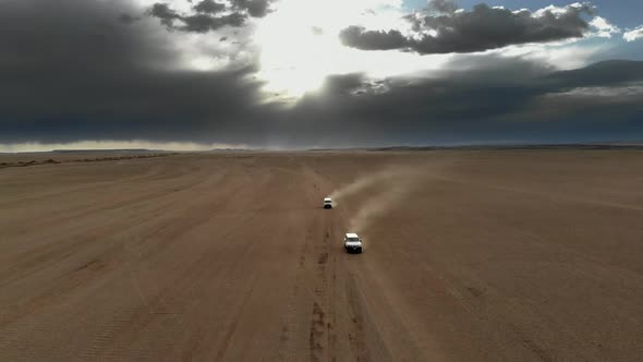 Vehicles Driving on Wide Dirt Roads in Central Asian Steppes alt