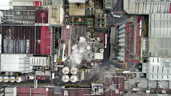 cenital dron shot of beer factory at the morning with water steam alt