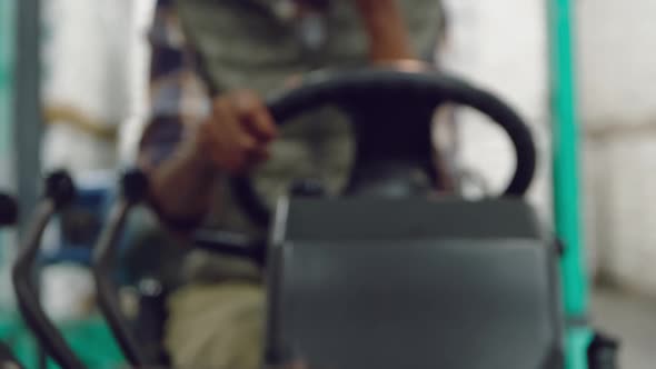 Female worker driving forklift in a warehouse alt