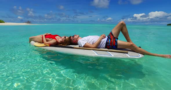 Happy couple married on vacation enjoy life on beach on white sand 4K background alt