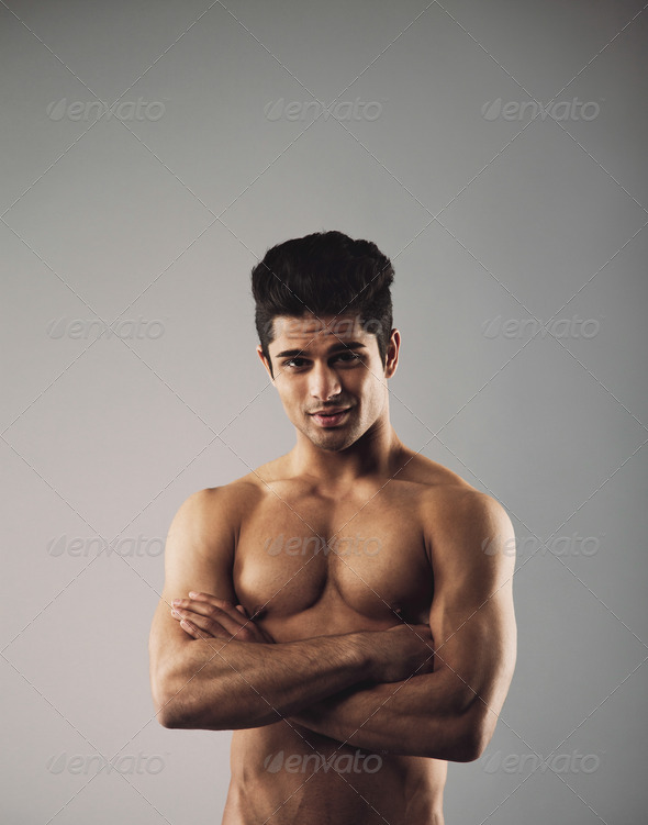 Muscular young man showing off his defined body Stock Photo by jacoblund