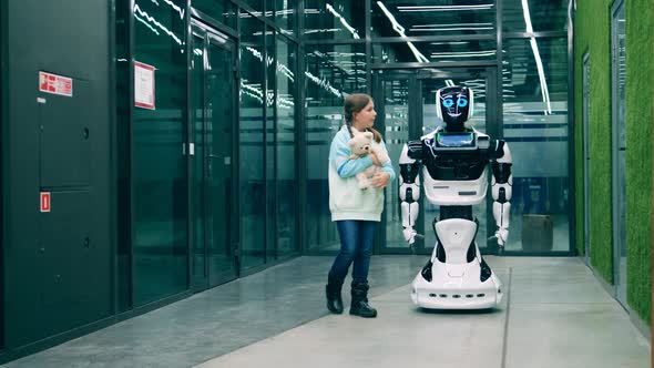 Little Kid Having a Conversation with a Futuristic Robot alt